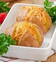 Baked potatoes stuffed with minced chicken and carrots photo