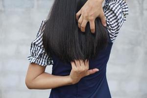 Backside of white woman back pain and ache concept,Itchy Asian woman in the back photo