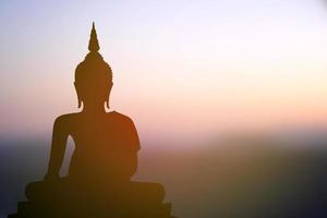 big buddha silhouette sunset background photo