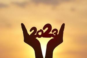 2023 silhouette on human hand. Happy new year concept. photo