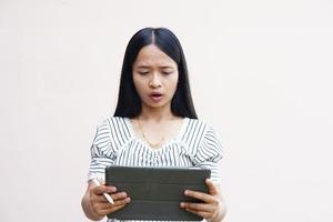 Businesswoman looking at a portable computer monitor Glad to have more profit photo