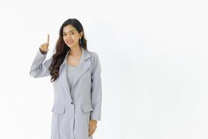 Young asian business woman stand showing one finger up with smiling face on white isolated background. photo