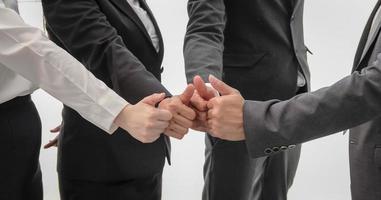 Asian business group thumbs up together on white isolated background. Business unity and teamwork concept. photo