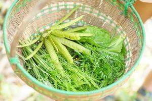 Various green vegetables in a basket photo