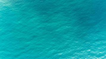 Ocean water texture. Aerial view of sea surface. Top view of transparent turquoise ocean water surface. photo