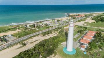 Low angle view of lighthouse at top fo leafy dune in Natal, Brazil photo