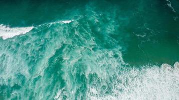 Top View texture Waves, Foaming and Splashing in the Ocean, Sunny Day photo