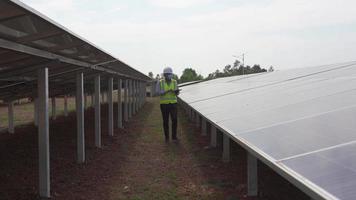 Long shot footage engineers inspecting solar panels for solar power generation