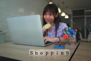 Teenager shopping online with credit card photo