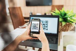 New form of payment of bills and bills in Brazil. Woman holding cell phone with pix app with QR Code, x close-up of the screen. photo