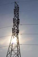 Silhouette of high voltage pylons. photo