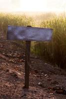 Old wooden sign on the ground. photo