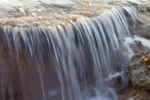 Blurred stream waterfall. photo