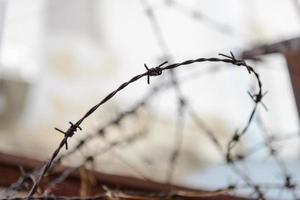 barbed wire fence lack - symbol of danger photo