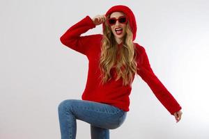 Closeup excited screaming young woman. shock, Shocked girl in red hoodie. Wow, surprised female. Fashion sweatshirt isolated on white background, face in red sunglasses. Beautiful, selective focus photo