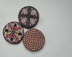 Collection of kopiah hat or peci with a variety of color and shape motifs. Peci that is usually used for Muslim men while praying to the mosque. Islamic cap isolated on white background. Ied mubarok. photo