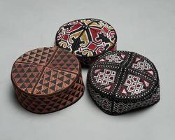 Collection of kopiah hat or peci with a variety of color and shape motifs. Peci that is usually used for Muslim men while praying to the mosque. Islamic cap isolated on white background. Ied mubarok. photo