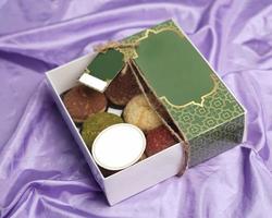 Eid hampers or parcels. Cake box containing creampuff or craquelin in various flavors and colors. Cake Box decorated with space for the customer's brand name. Cake Mockup template design. focus blur. photo