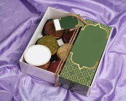 Eid hampers or parcels. Cake box containing creampuff or craquelin in various flavors and colors. Cake Box decorated with space for the customer's brand name. Cake Mockup template design. focus blur. photo