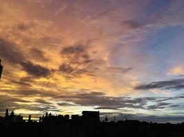 very beautiful twilight sky, a blend of orange and blue colors. beautiful view of the evening sky. clouds, sky and rainbow that adorn the atmosphere in the afternoon. Evening view in Jakarta. blur photo