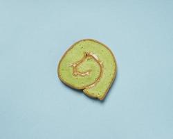 Slices of bread covered with cream butter are then rolled and sliced. Bread in the shape of a roll. The green color usually indicates the pandan flavor in the bread. Indonesian cake taste. focus blur. photo