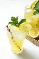 Fresh Lemonade or mojito cocktail with lemon, mint and ice photo