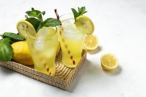 Fresh Lemonade or mojito cocktail with lemon, mint and ice photo
