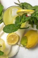 Fresh Lemonade or mojito cocktail with lemon, mint and ice photo