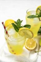 Fresh Lemonade or mojito cocktail with lemon, mint and ice photo
