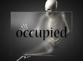 occupied word on glass and skeleton photo
