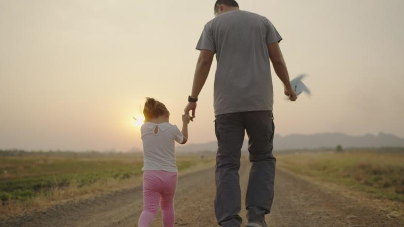 4k Video slow-motion, An Asian father took his daughter's hand for a walk. The right-hand holds a turbine During the sunset Family concept. 7432621 Stock Video at Vecteezy
