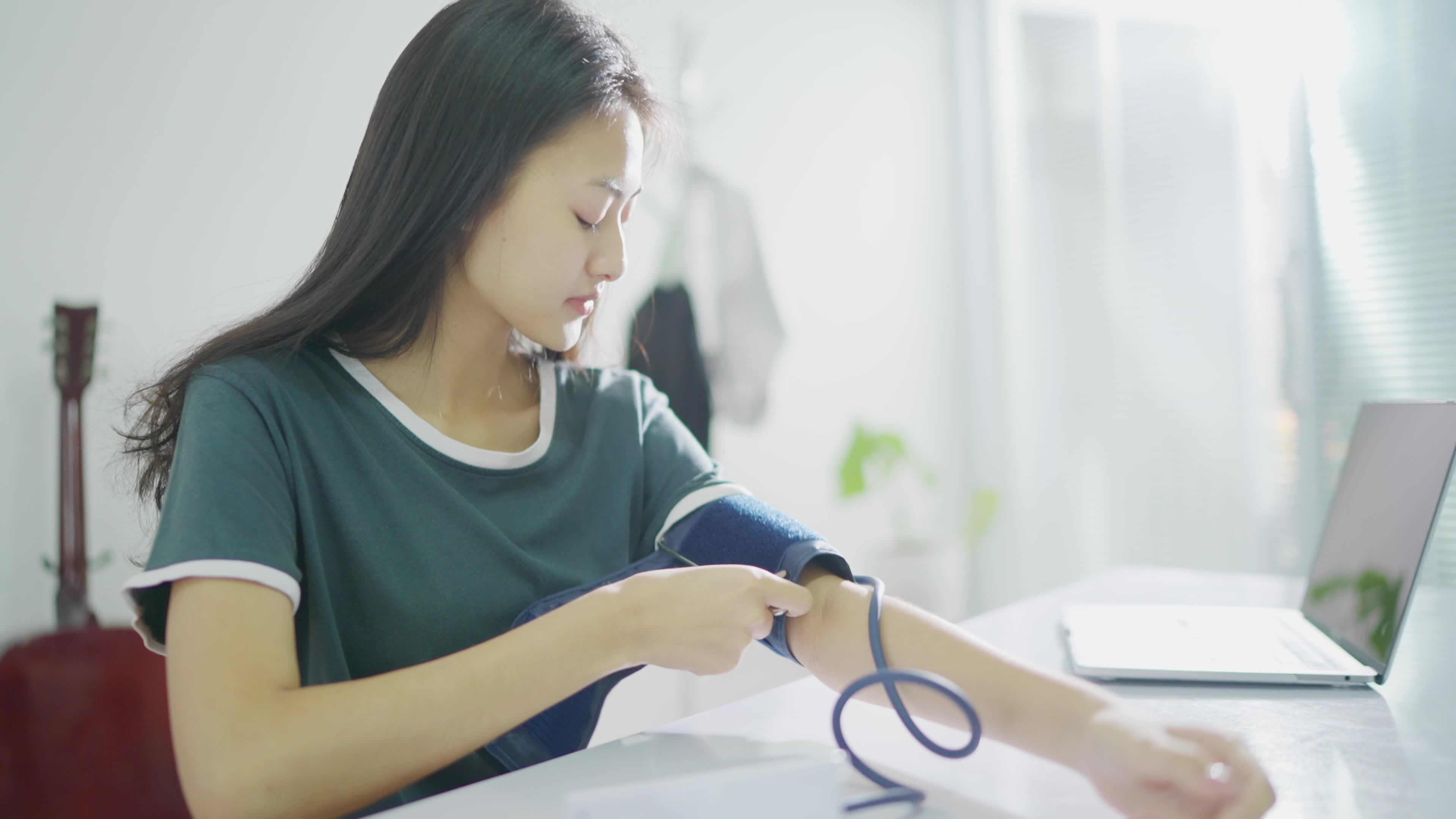 Asian woman Self monitoring , analysing, check blood pressure. Healthcare equipment, devices at home