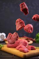 Raw meat. Fresh beef on wooden background photo
