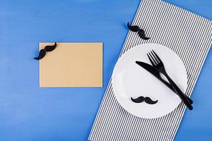 Table setting on Fathers day with cutlery and mustache . Happy Fathers day. Background of fathers day. photo