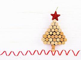 Christmas tree made of wine corks on white background. Mockup postcard with Christmas tree and copy space for text. Top view. photo