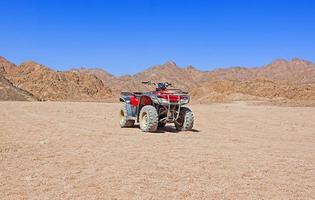 Red quad bike in the desert photo