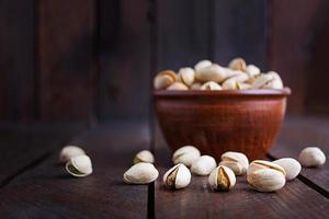 Pistachio nuts on wooden background. Roasted salted pistachios. photo