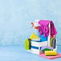 Cleaning service concept. Colorful cleaning set for different surfaces in kitchen, bathroom and other rooms. photo