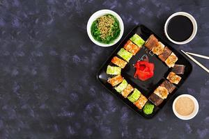Sushi roll on dark background. Top view photo