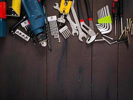 Working tools on wooden rustic background. Top view. Copy space photo