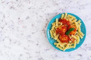 Meatballs with fusilli on white background