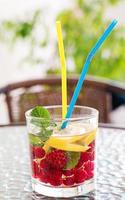 Cool refreshing mojito cocktail with lemon, mint and red currants. photo