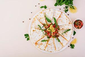 Quesadilla chicken and corn with salsa. Top view photo