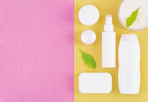 Set cosmetics SPA.  Mockup on pink-yellow background, place you design. Top view photo