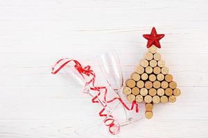 Christmas tree made of wine corks on white background. Mockup postcard with Christmas tree and copy space for text. Top view. photo