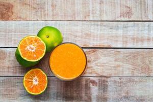 Orange juice on wooden table photo