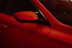 espejos laterales de primer plano del coche rojo para la seguridad del estacionamiento. foto