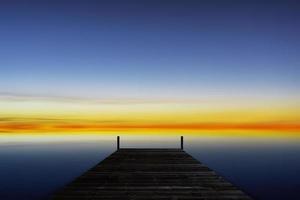 Old wooden pier with the sea in summer morning. photo