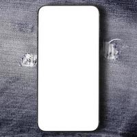 Smartphone on black denim jeans texture background. photo