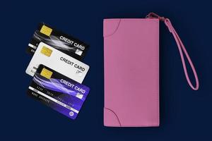 billetera de dama rosa y tarjetas de crédito en un fondo azul. foto